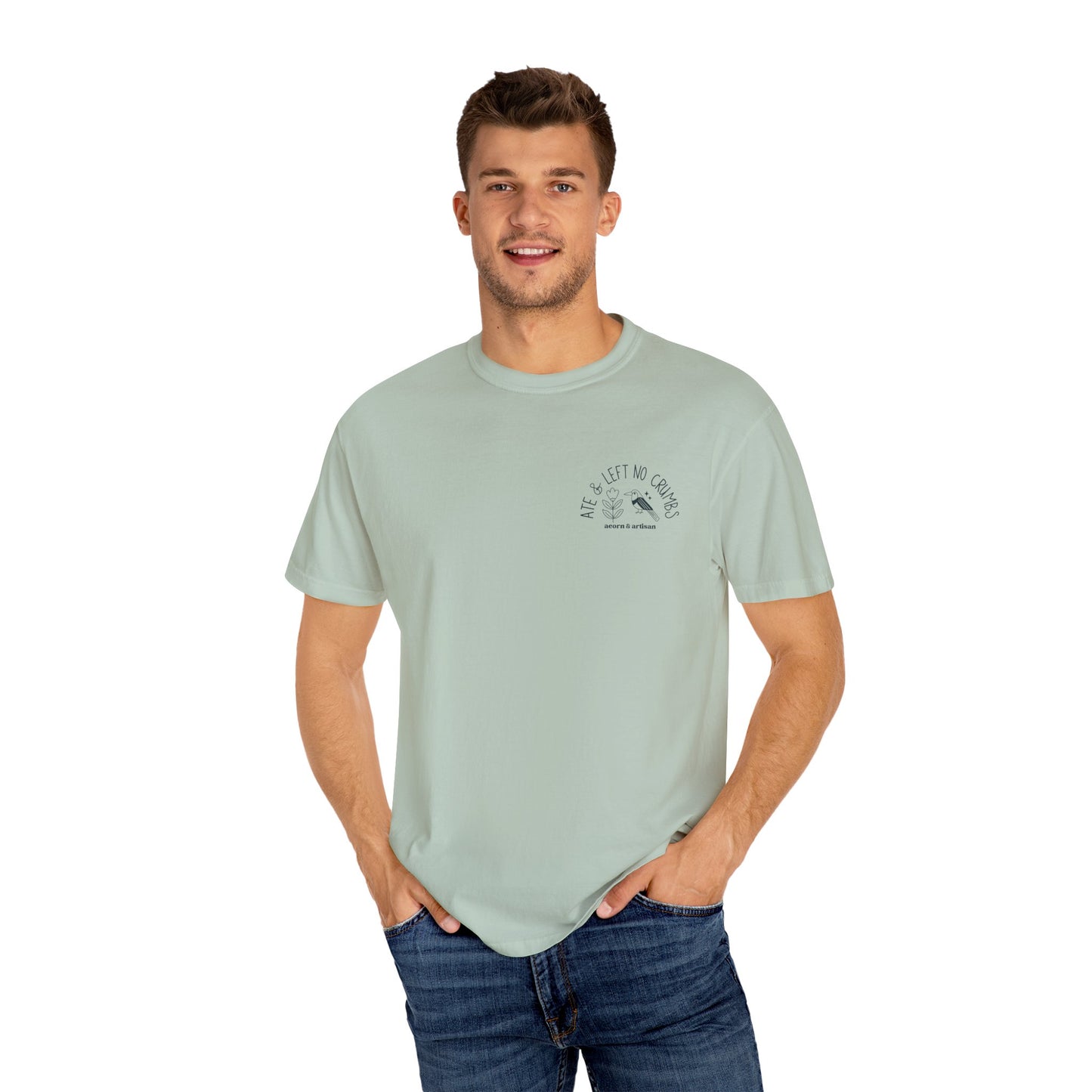 Man wearing a light green t-shirt with a graphic design on a white background