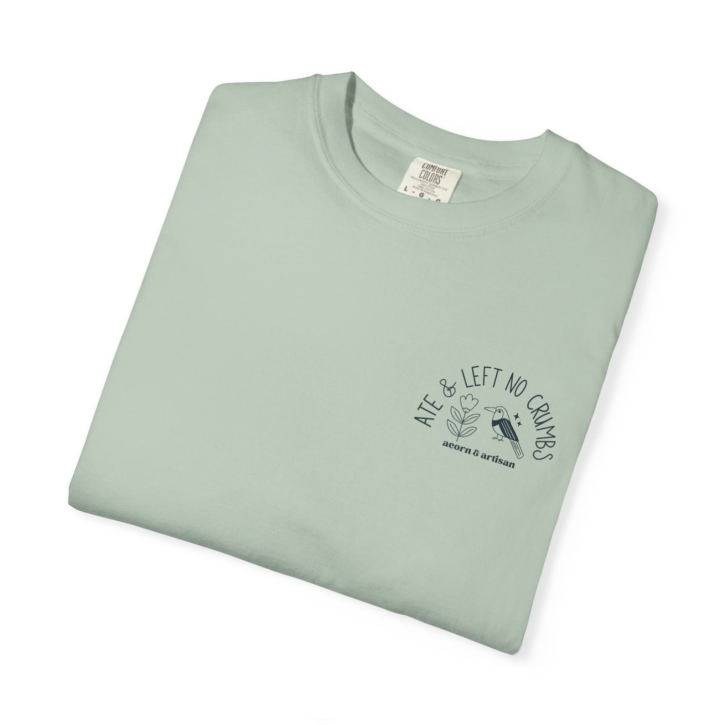 Folded light green t-shirt with text and graphic on a white background