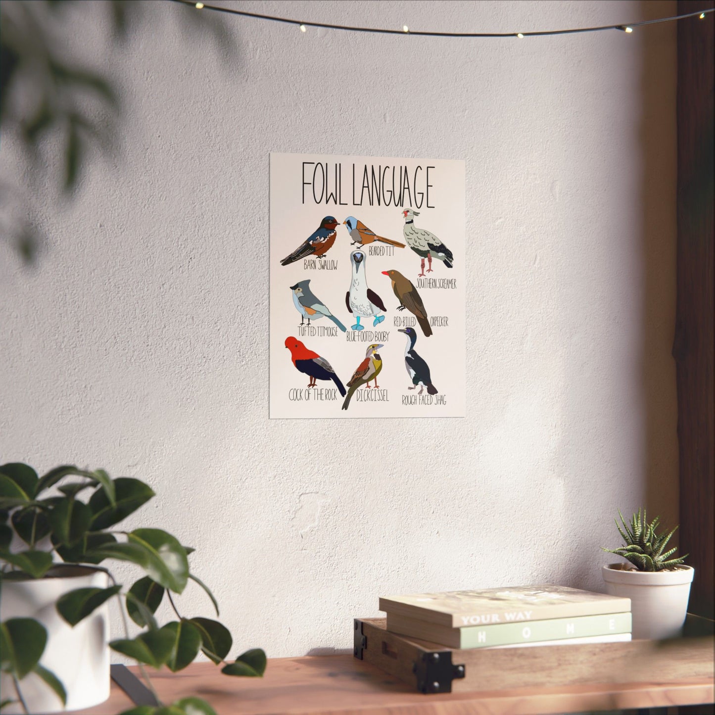 Humorous 'Fowl Language' poster with bird illustrations hanging on an office wall, adding personality and charm to the workspace.