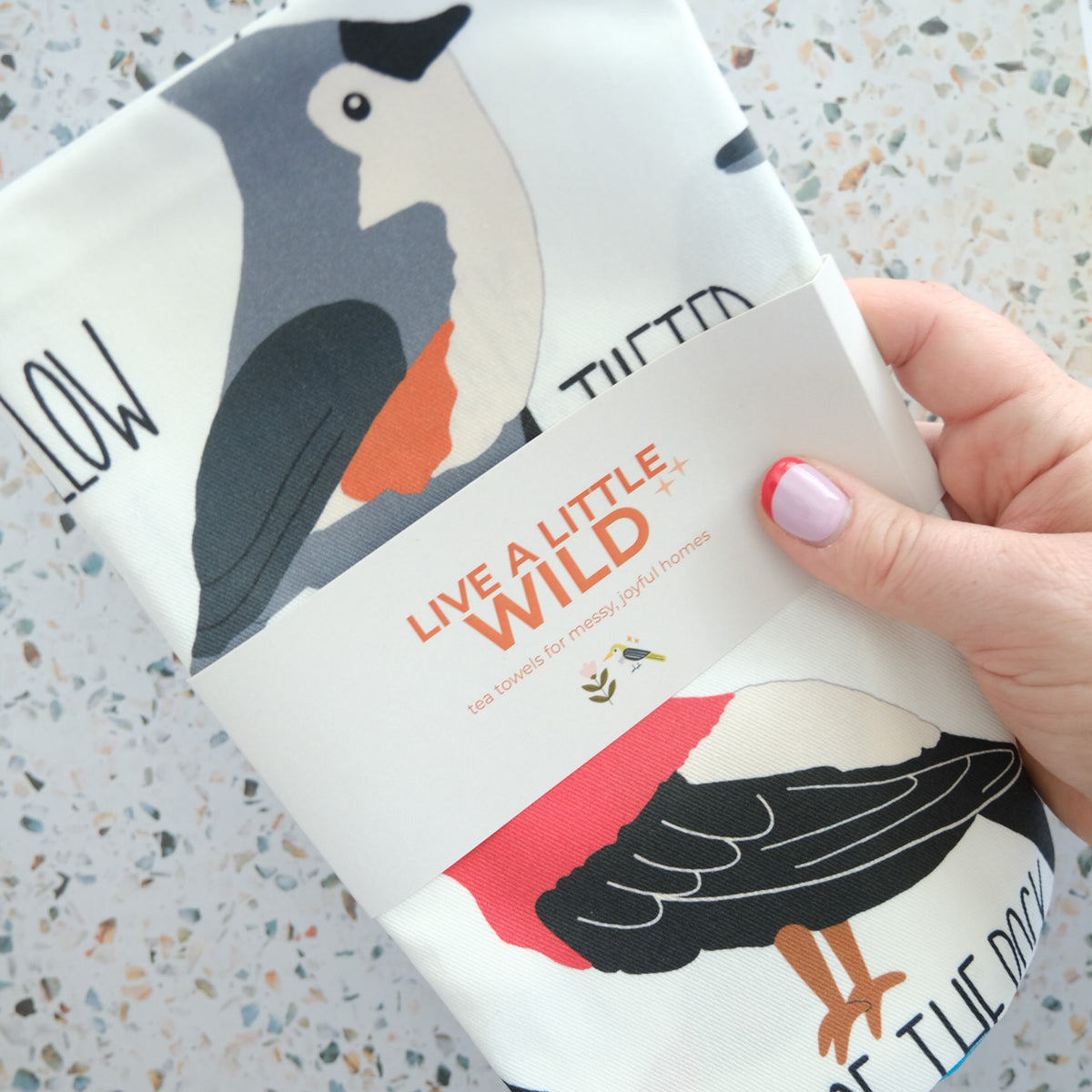 Fowl Language Tea Towel styled in a colorful lifestyle setting