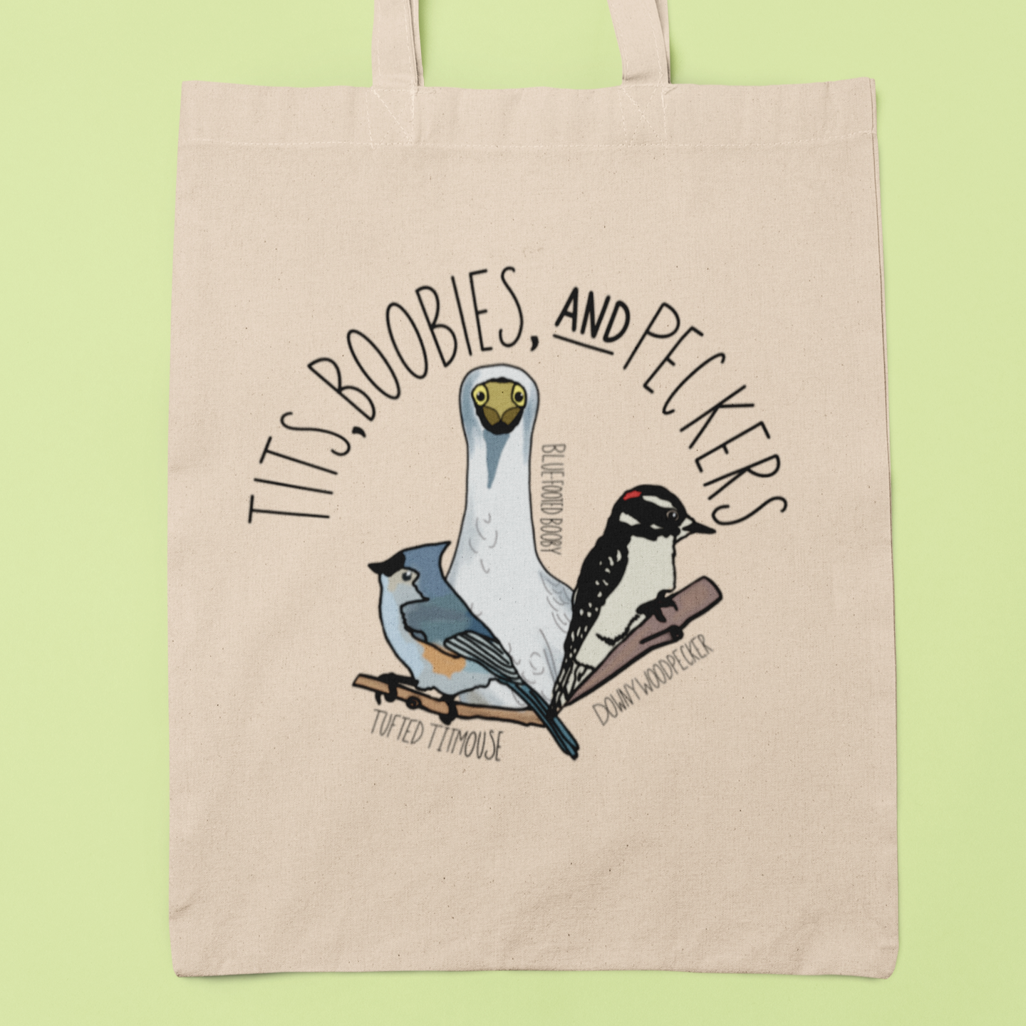 Canvas tote bag featuring the playful 'Tits, Boobies, and Peckers' design with colorful bird illustrations, displayed against a light background. Includes durable black handles.