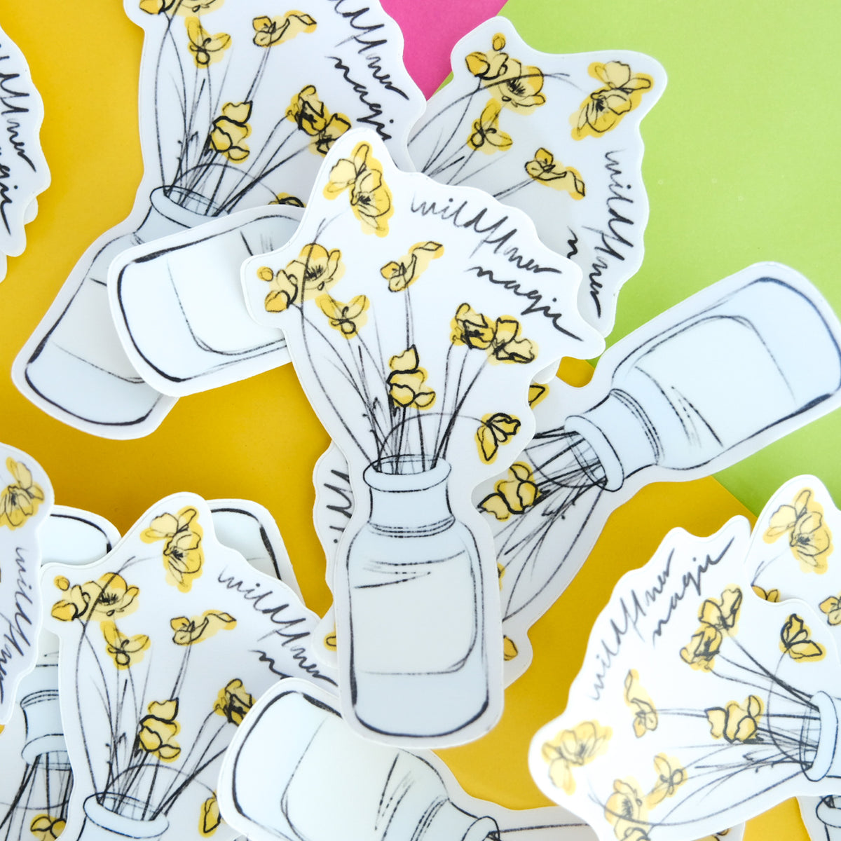 Wildflower Magic vinyl sticker with flowers in an outlined jar displayed with matching pieces.
