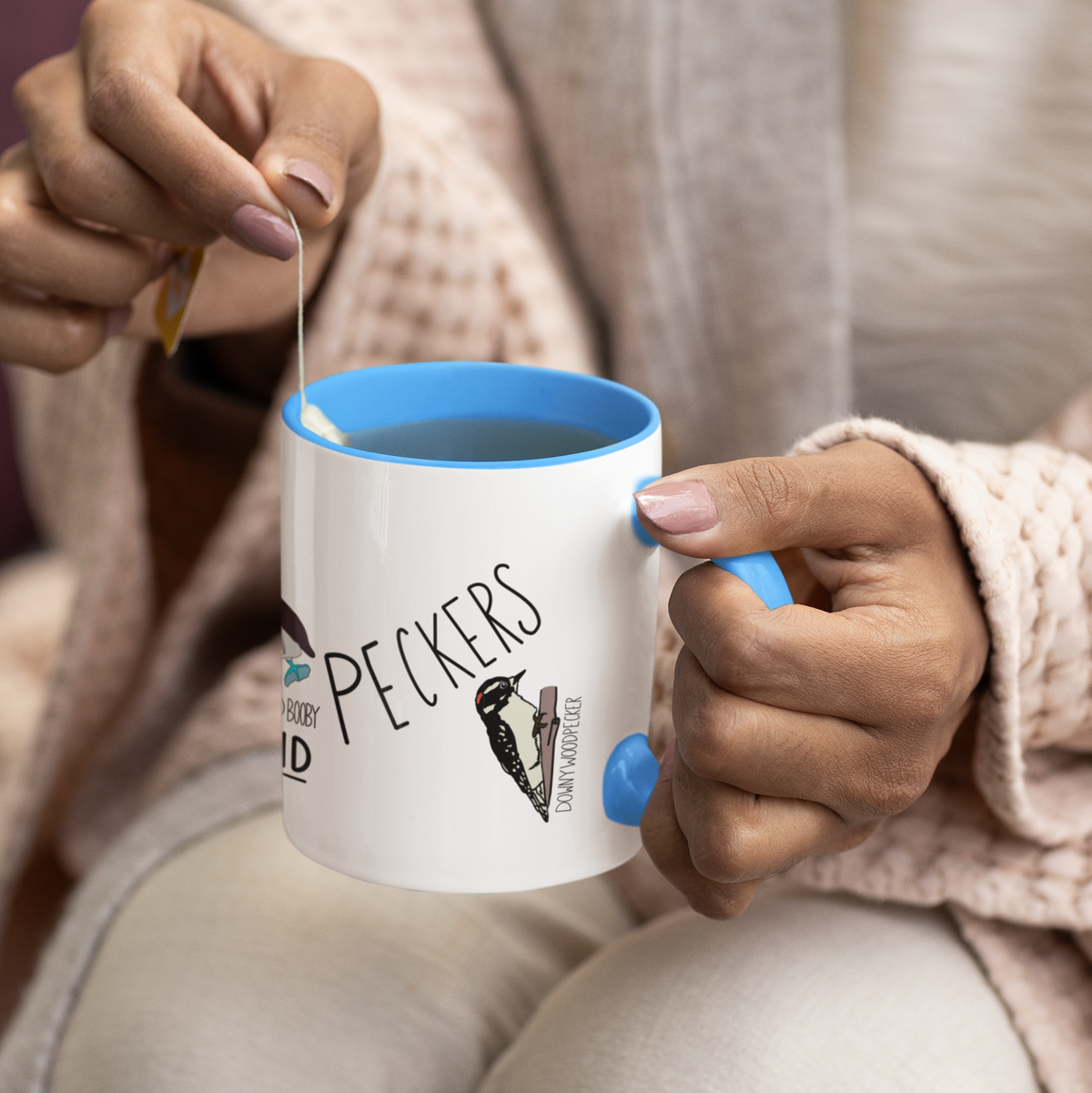 Tits, Boobies & Peckers white ceramic mug with blue handle and bird illustrations.