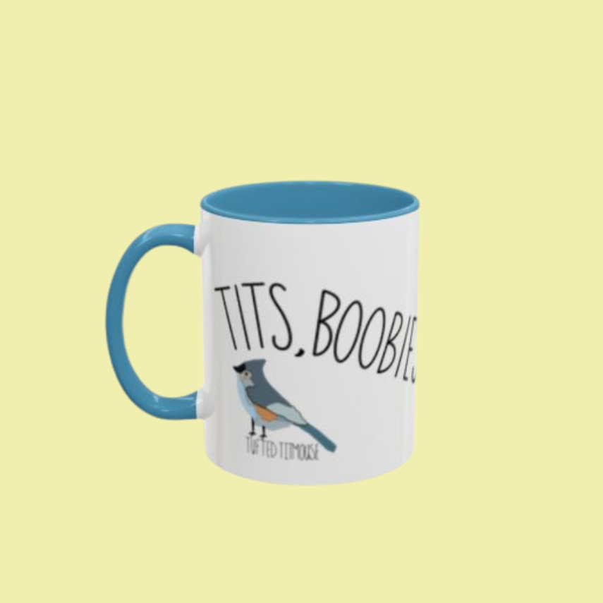 Tits, Boobies & Peckers white ceramic mug with blue handle and bird illustrations.