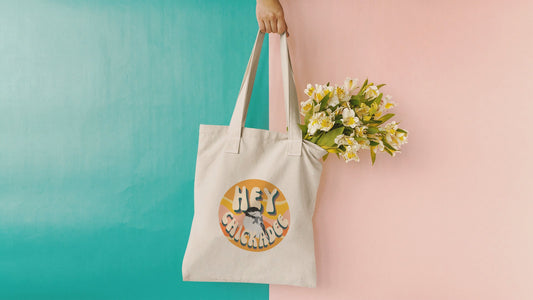 Video showcasing the 'Hey Chickadee' tote bag, rotating to reveal its charming retro-inspired design with a chickadee illustration, perfect for bird lovers.