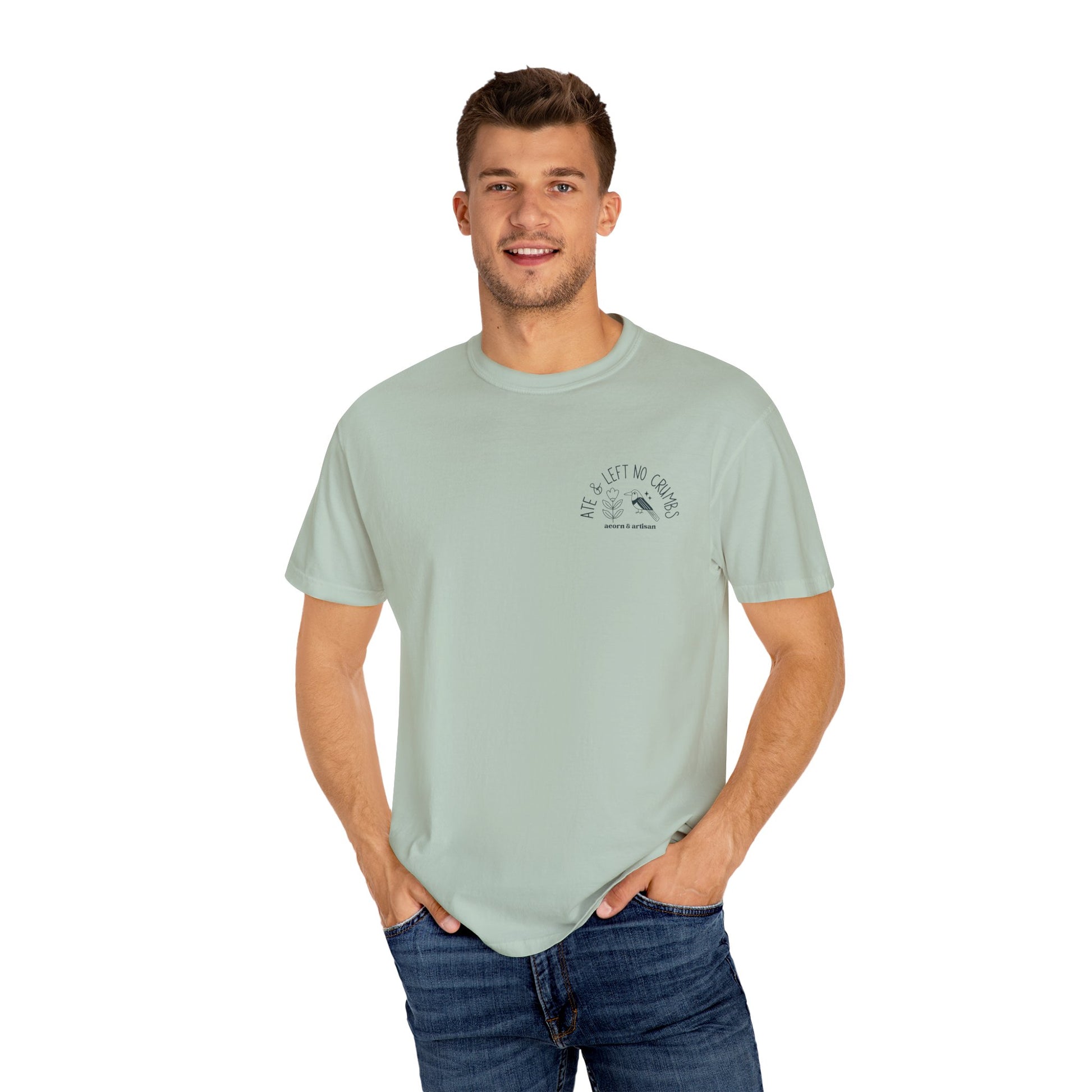 Man wearing a light green t-shirt with a graphic design on a white background