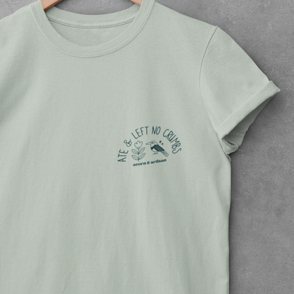 Mint green t-shirt with a graphic design on a hanger against a gray background