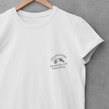 White t-shirt with text and graphic on a hanger against a gray background