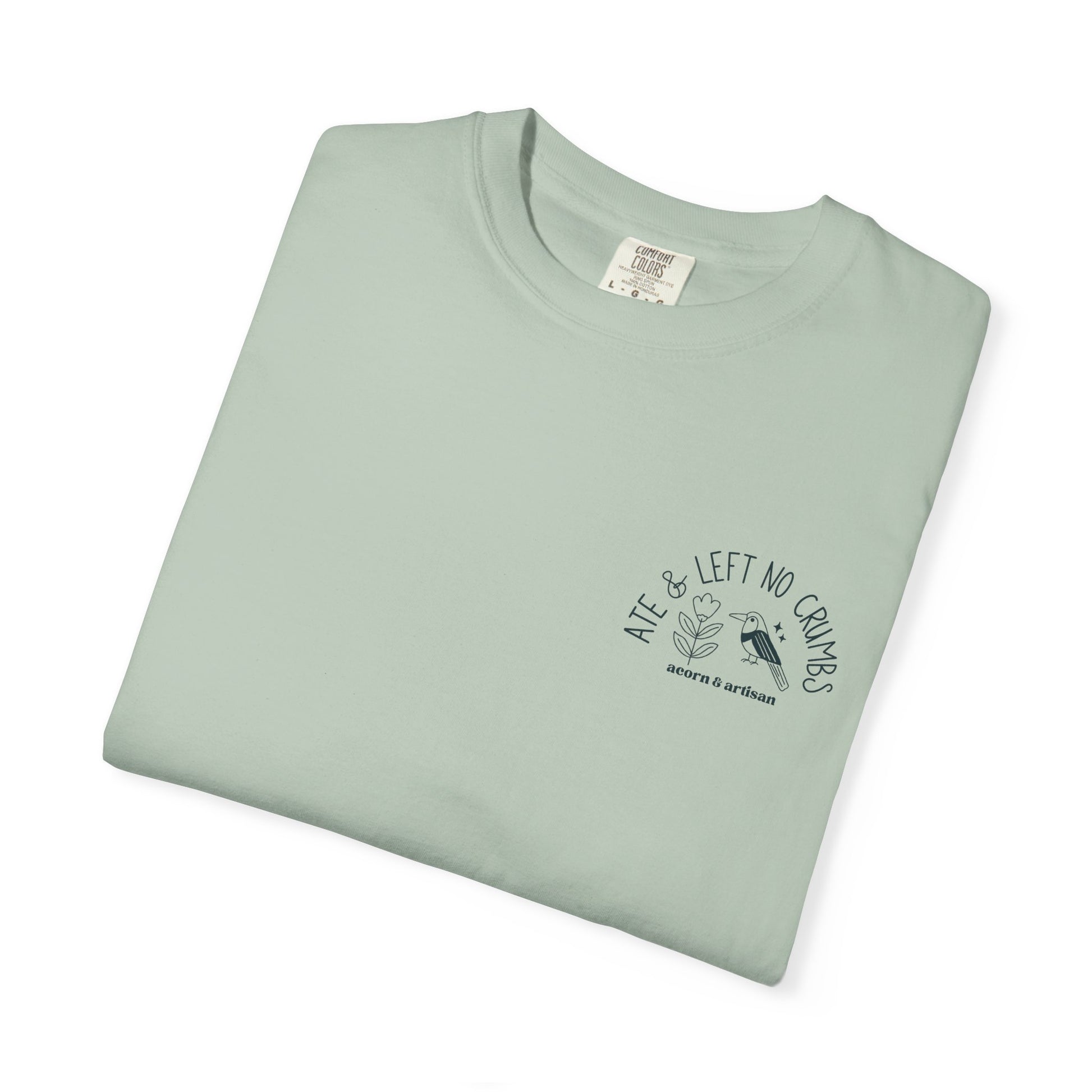 Folded light green t-shirt with text and graphic on a white background