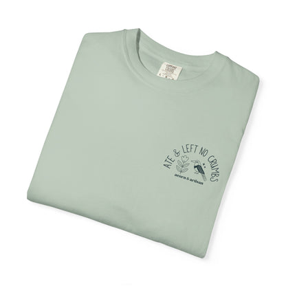 Folded light green t-shirt with text and graphic on a white background