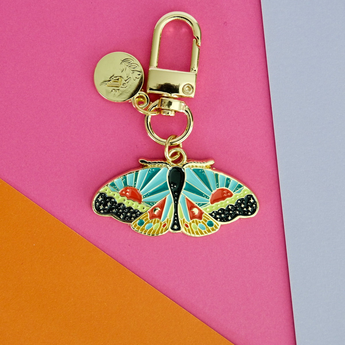 Flat lay of Cosmic Moth Enamel Keychain, showing the full design