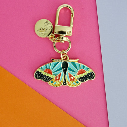 Flat lay of Cosmic Moth Enamel Keychain, showing the full design