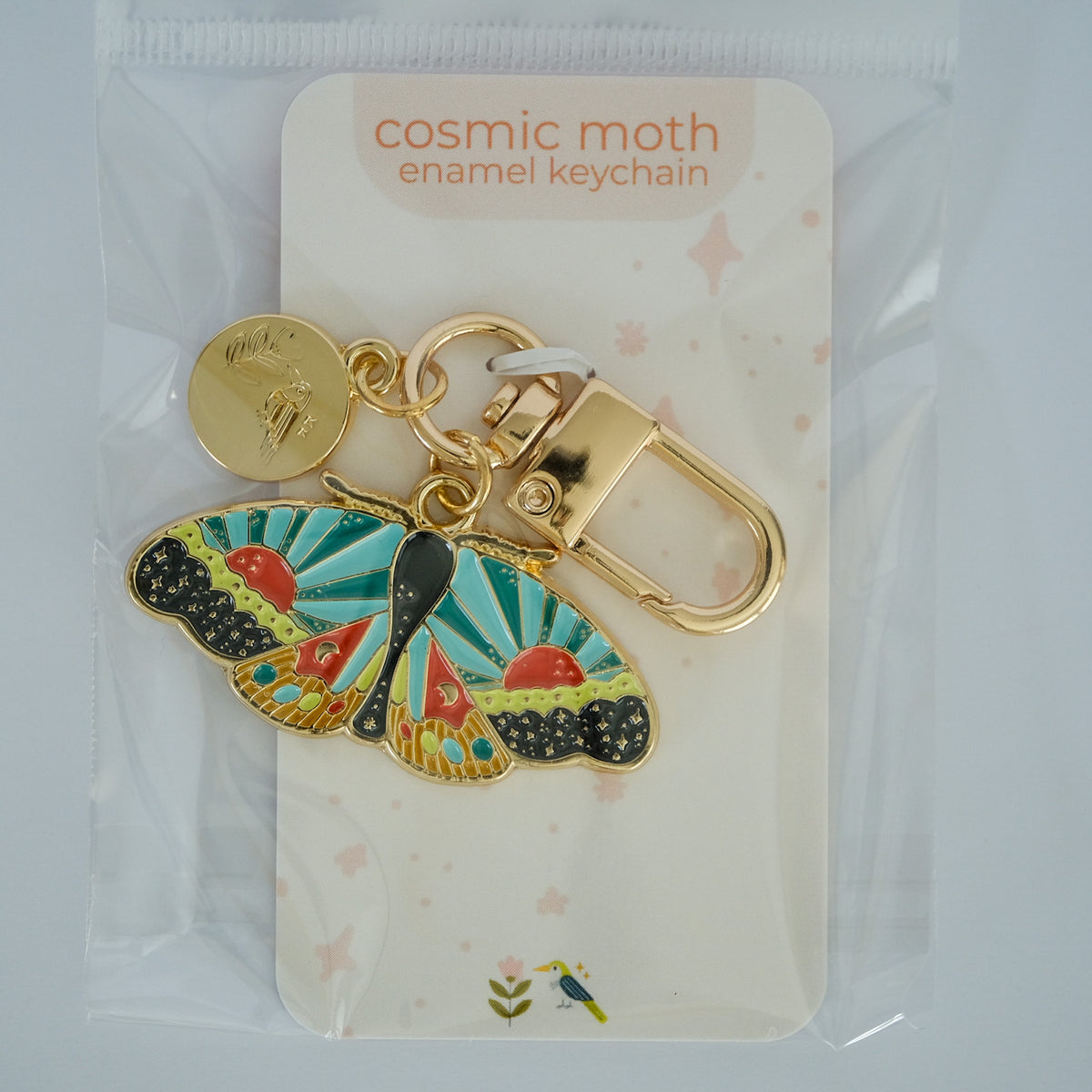 Cosmic Moth Enamel Keychain with Acorn & Artisan retail packaging