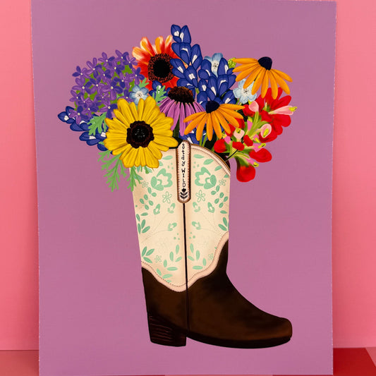 Cowboy boot with colorful flowers on a pink background