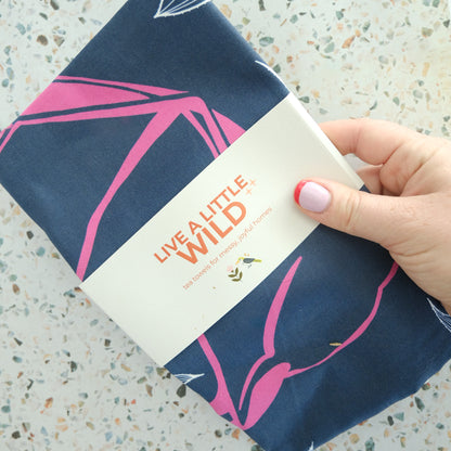 Midnight Pollinator Tea Towel styled in a colorful lifestyle setting