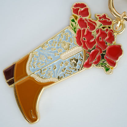 Close-up of Poppy Cowgirl Boot Enamel Keychain, showing the illustrated design and product details