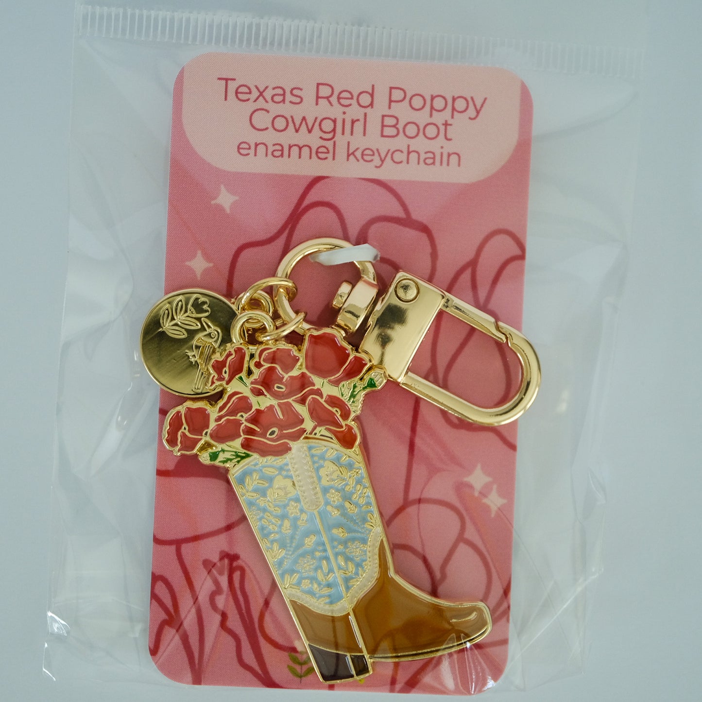 Poppy Cowgirl Boot Enamel Keychain with Acorn & Artisan retail packaging