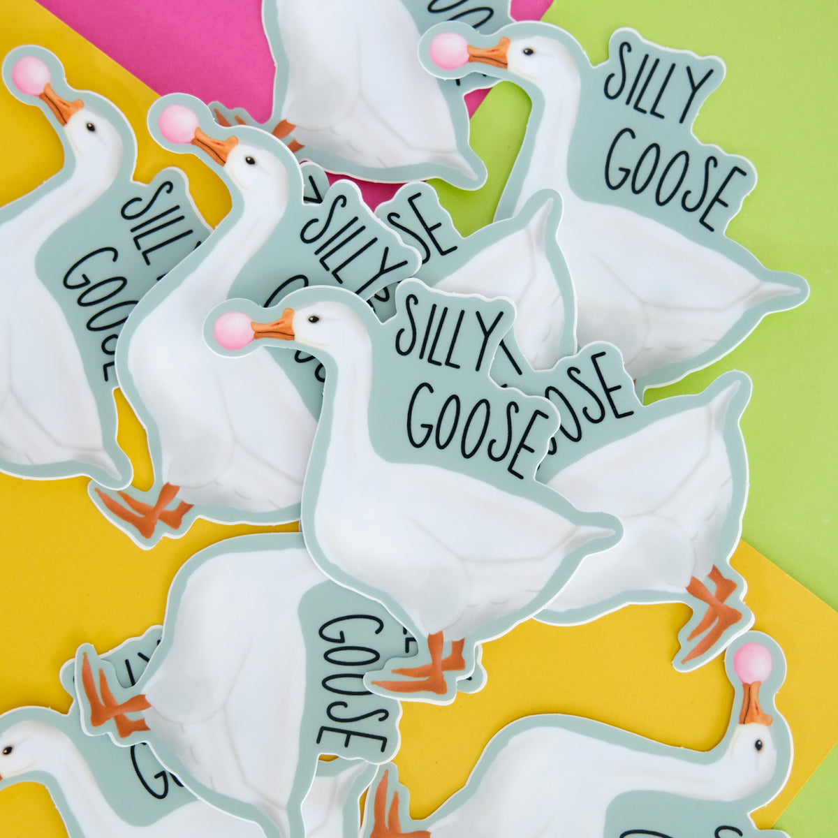 Silly Goose vinyl sticker with a white goose blowing pink bubblegum displayed with matching pieces.