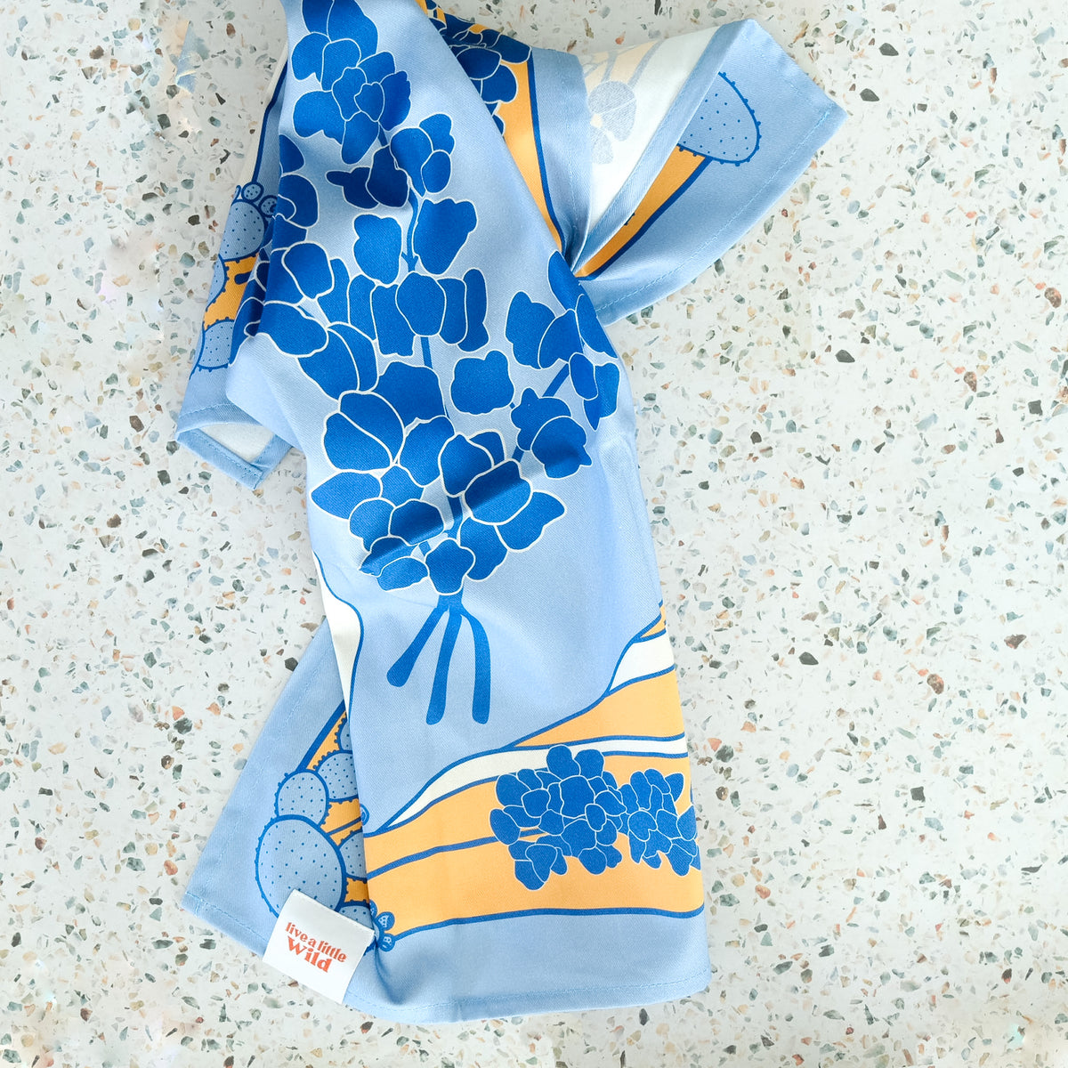 Flat lay of Texas Hill Country Bluebonnets Tea Towel, showing the full design