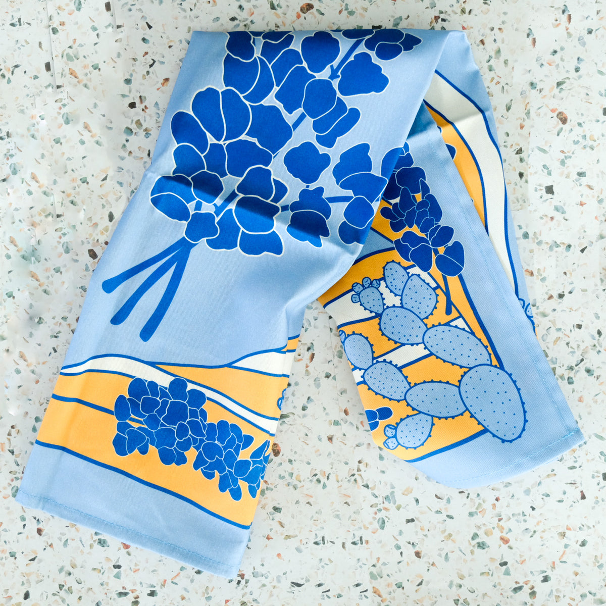 Flat lay of Texas Hill Country Bluebonnets Tea Towel, showing the full design