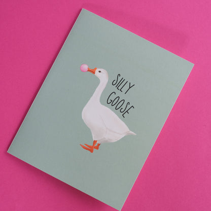 Silly Goose greeting card with a white goose blowing pink bubblegum.