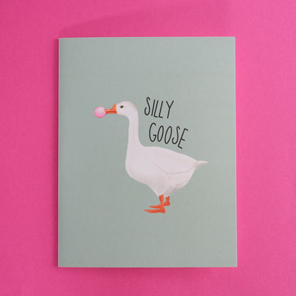Silly Goose greeting card with a white goose blowing pink bubblegum.