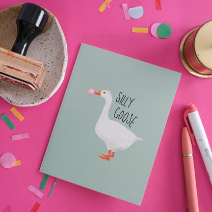 Silly Goose greeting card with a white goose blowing pink bubblegum.
