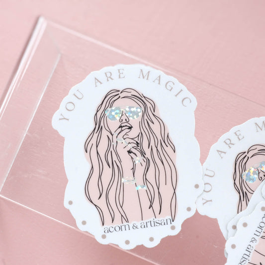 boho styled woman with jewelry and sunglasses under the wording "you are magic"